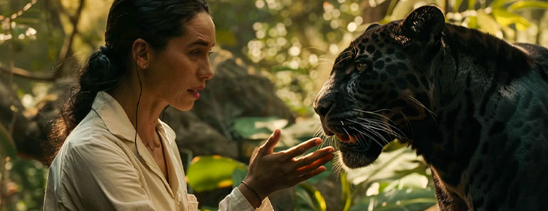 A female Doctor Dolittle talks to a big cat.